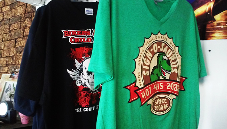 Screen printed green t-shirt with Sign-O-Saurus logo